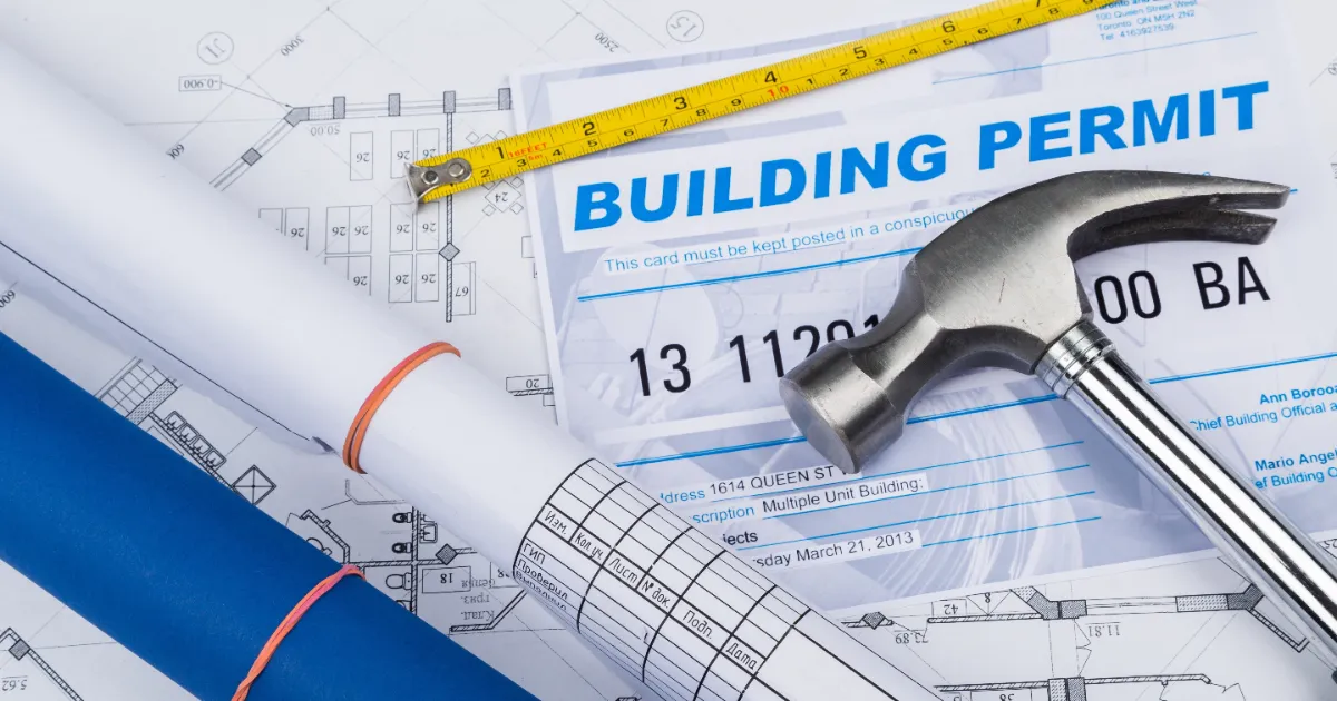 a building permit document and construction plans laid out