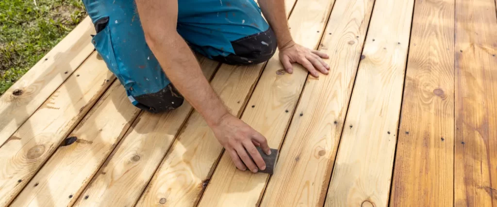 a person working on a wooden deck